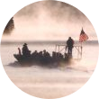 A barge crosses the lake in fog.