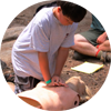 A scout practices CPR.