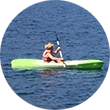 A scout paddles a kayak.