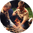 Two scouts build a fire.