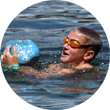 A happy swimmer grabs a float.
