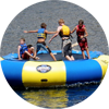 Scouts jump on a water trampoline.
